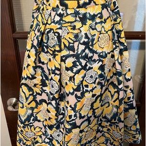 Floral print full skirt. Pleats round the whole skirt. Side pockets
